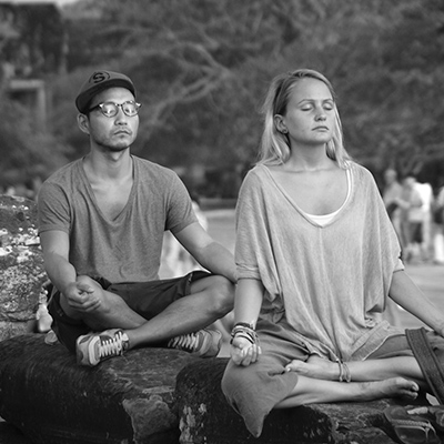 man and woman meditating IAM®